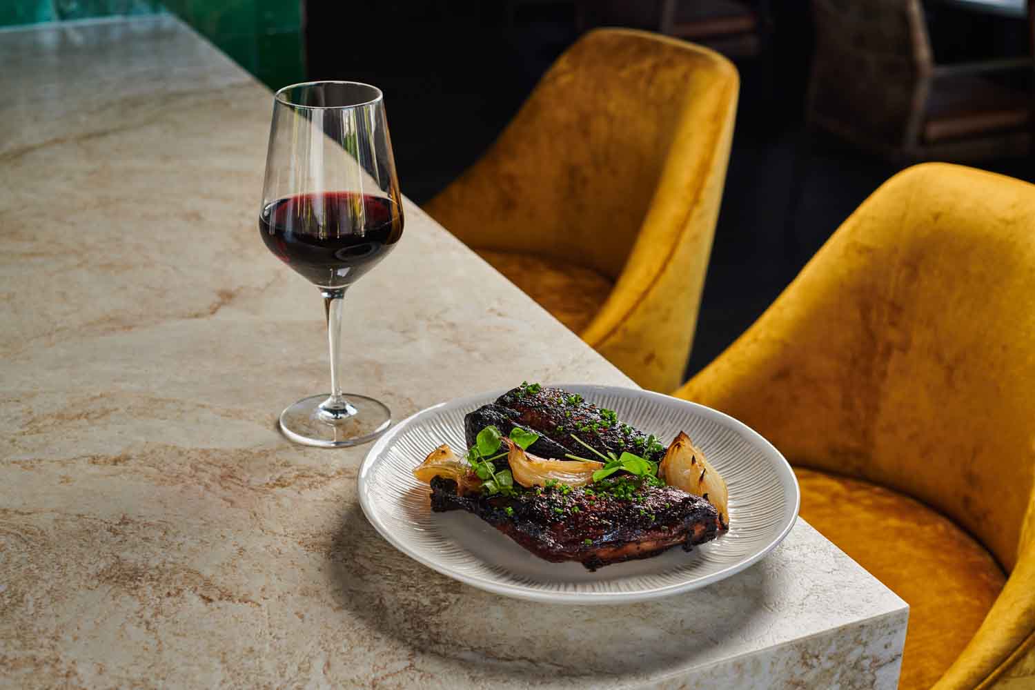 Steak on plate and glass of wine